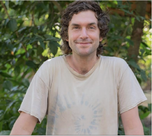Smiling man in beige tie-dye t-shirt outdoors