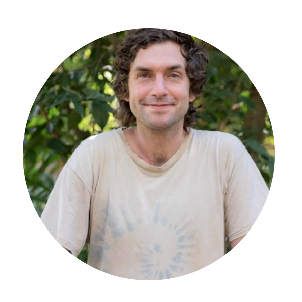 Smiling man in beige t-shirt outdoors